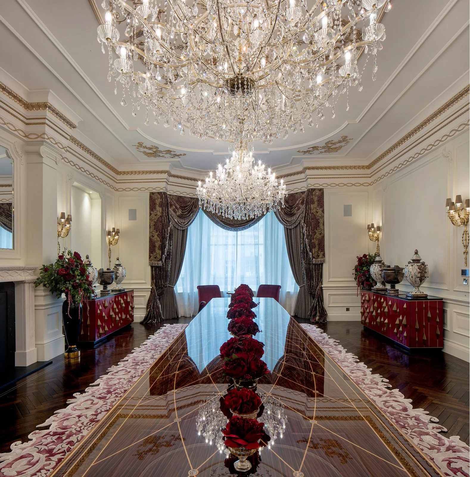 Formal dining room with crystal chandeliers by NOOR Design & Build